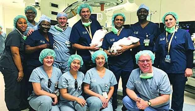 Sidra Medicine staff are seen with the first set of twins.