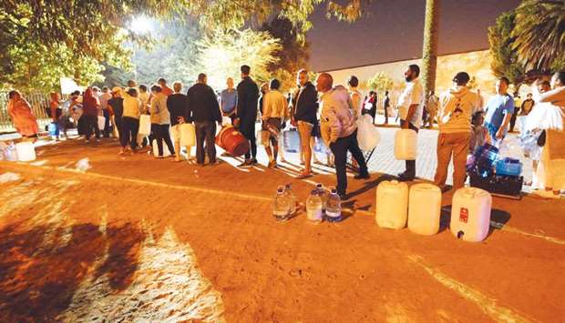 People queue to collect water from a spring in the Newlands suburb of Cape Town.