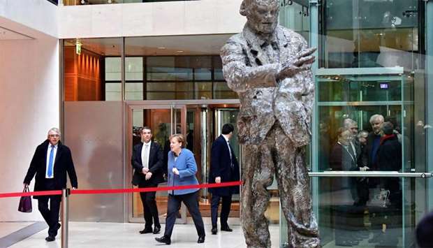 German Chancellor Angela Merkel (3rdL) arrives at the Social Democrats Party (SPD) headquarters as the Chairman of the Bavarian Christian Social Union (CSU) Horst Seehofer (R) takes the elevator