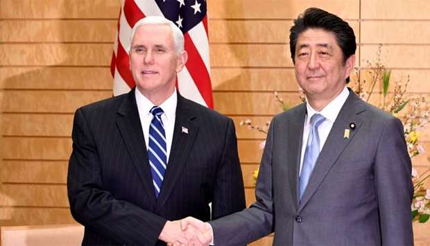 US Vice President Mike Pence (L) shakes hands with Japan's Prime Minister Shinzo Abe