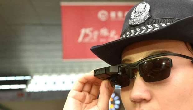 A police officer wearing a pair of smartglasses with a facial recognition system at Zhengzhou East Railway Station