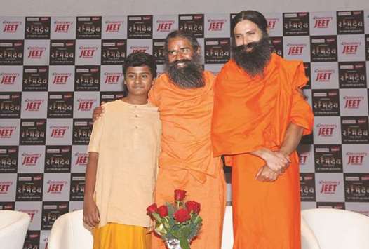 Baba Ramdev with actor Kranti Prakash Jha (right) and child artiste Naman Jain during a press conference on the launch of a biopic series Swami Ramdev: Ek Sangharsh in New Delhi yesterday.
