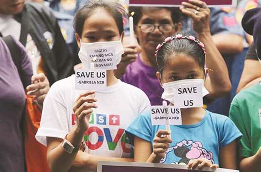 Members of various groups and their children hold a rally in front of the Department of Health building in Manila, urging officials to hold a dialogue with parents of children who were administered Dengvaxia.