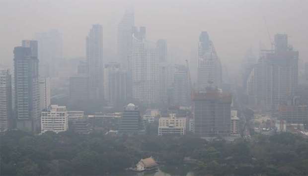 The skyline is seen through morning air pollution in Bangkok, Thailand