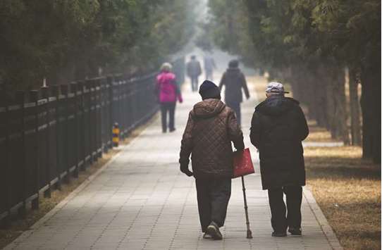 People walk through Tiantan Park in Beijing. Ageing in the worldu2019s most populous country means pension contributions by workers no longer cover retiree benefits, forcing the government to fill that gap since at least 2014. The State Council said last year that about a quarter of Chinau2019s population will be 60 or older by 2030, up from 13.3% in the 2010 census.