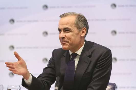 Bank of England governor Mark Carney gestures while speaking during the banku2019s quarterly inflation report news conference in London yesterday. u201cIt will be likely to be necessary to raise interest rates to a limited degree in a gradual process but somewhat earlier and to a somewhat greater extent that what we had thought in November,u201d Carney said.