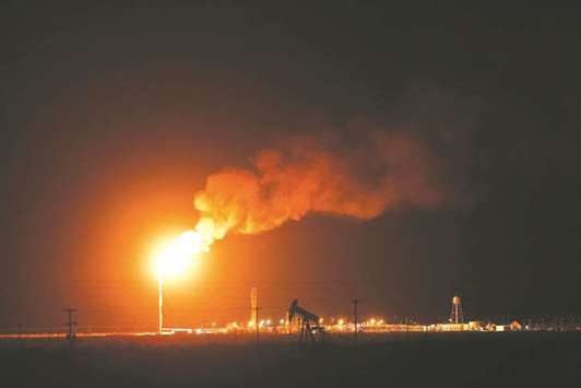The silhouette of an oil pump jack is seen near a flare at night in the oil fields surrounding  Midland, Texas (file). In the two years since Washington lifted a 40-year ban on oil exports, tankers filled with US crude have landed in more than 30 countries.