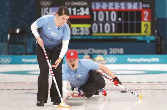 Becca Hamilton and Matt Hamilton of the US in action during the  Pyeongchang 2018 Winter Olympics curling event against Canada at the Gangneung Curling Centre yesterday. (Reuters)