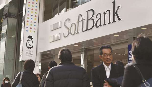 The logo of Japanese mobile service provider SoftBank is displayed at an entrance of a shop in Tokyou2019s shopping district Ginza. Swiss Re said it is in talks to sell a minority stake to SoftBank Group in a deal that could be worth $10bn or more and would mark Japanese companyu2019s biggest move yet into financial services.