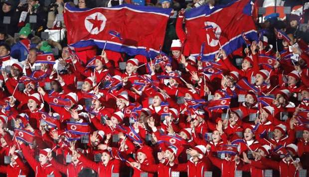 Cheerleaders of North Korea wave their national flags as they wait the start of the opening ceremony.