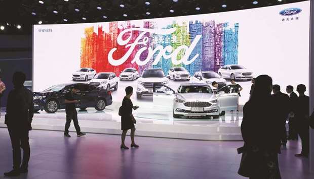 Visitors look at Ford models in Guangzhou. Ford sold 75,990 vehicles in China in January, the firm said in a statement yesterday.