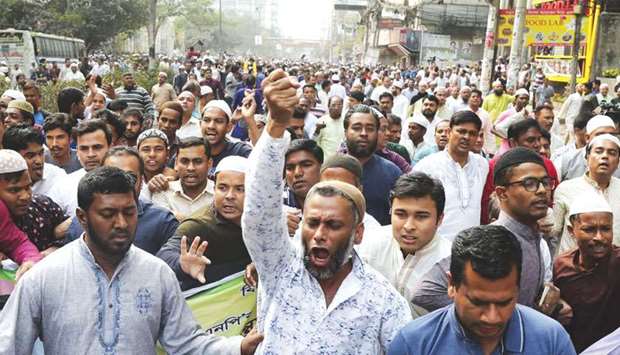 BNP activists shout slogans as they march along a street following the verdict in the corruption case of BNP chairperson Khaleda Zia, in Dhaka yesterday.