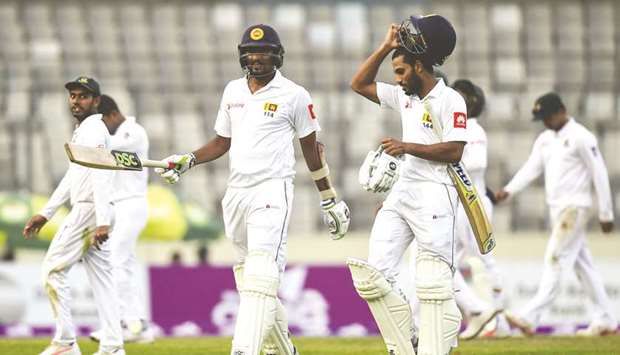Sri Lankau2019s Suranga Lakmal (left) and Roshen Silva (right) walk off the field after the second day of the second Test against Bangladesh at the Sher-e-Bangla National Cricket Stadium in Dhaka yesterday. (AFP)