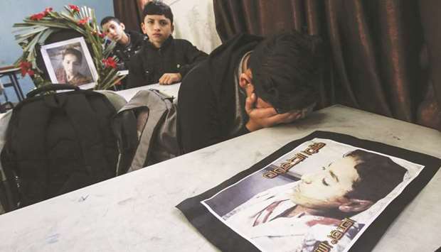 Classmates of Hassan Shalabi, 14, mourn his death at his school in Khan Yunis in the southern Gaza Strip, yesterday.