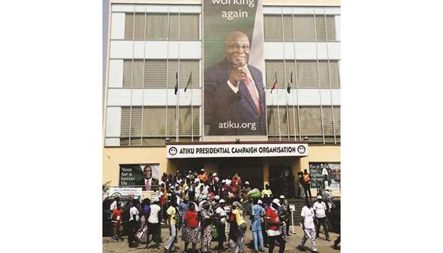 Supporters stand at the campaign headquarters of presidential candidate Atiku Abubakar following the cancellation of a campaign rally by the opposition Peoples Democratic Party (PDP) in Abuja yesterday.