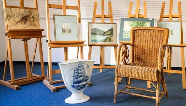 A picture taken on February 8 at the Weidler auction house in the southern German city of Nuremberg shows a wicker armchair, bearing a swastika, a vase and watercolours which are presumed to have belonged to Adolf Hitler.