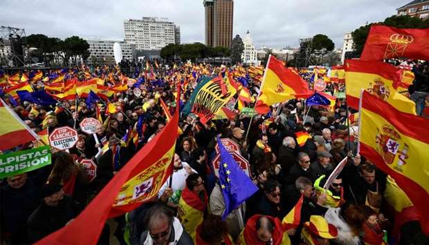 Right-wing protesters wave Spanish flags during a demonstration in Madrid against Spanish Prime Minister Pedro Sanchez