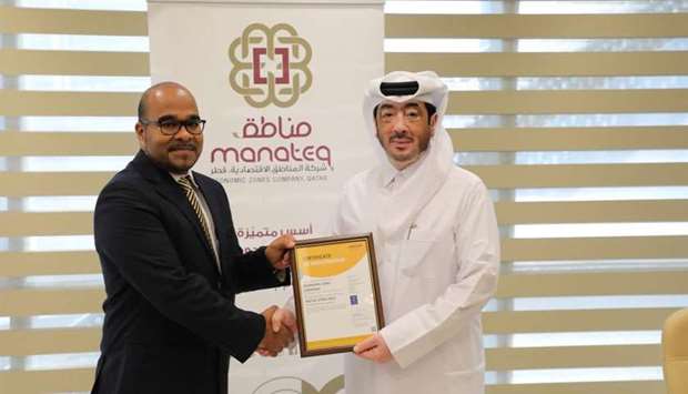 Manateq CEO Fahad Rashid al-Kaabi receiving the certification.rnrn
