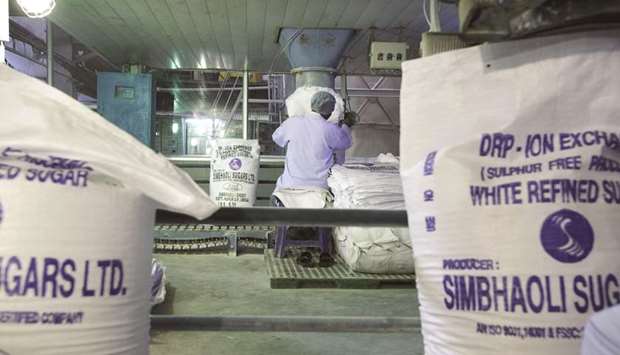 A worker fills bags with refined sugar at the Simbhaoli Sugars  manufacturing plant in Simbhaoli, Uttar Pradesh, India (file). India is on track for a record crop this season, extending a global surplus into a second year.