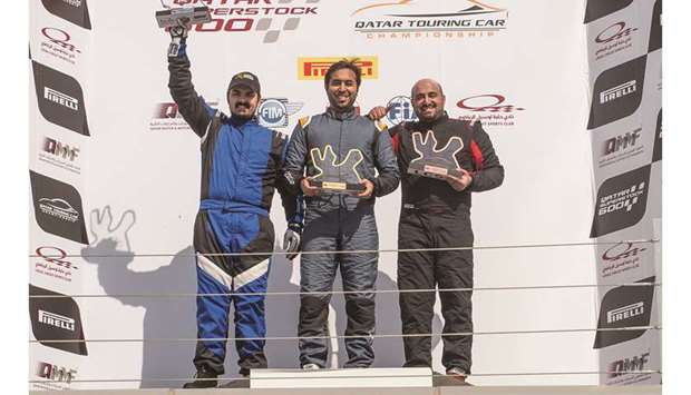 Second-placed Mohamed al-Khaiat (left), winner Abdulla al-Khelaifi (centre) and Ahmed al-Asiri celebrate on the podium of race one of the Qatar Touring Car Championship at the Losial International Circuit.