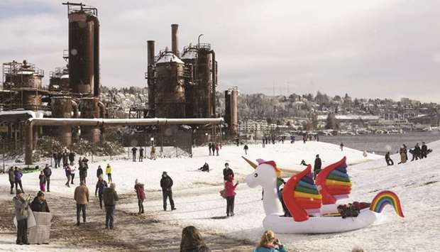 People play at Gas Works Park after a large storm blanketed Seattle with snow on Saturday.