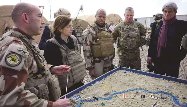 (From left) French Major of the Wagram Task Force Francois-Regis Legrier  explains military positions on a sand map to French Defence Minister Florence Parly, French General Jean-Marc Vigilant, US Army General Paul La-camera, and French ambassador to Iraq Bruno Aubert, at a French artillery base near Al-Qaim in Iraqu2019s western Anbar province opposite Syriau2019s Deir Ezzor region.