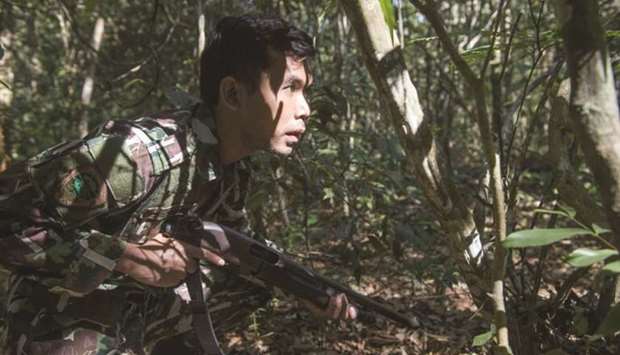A Thai forest ranger approaches a target during a mock raid on u2018poachersu2019 in Khao Yai National Park, as part of training to tackle the lucrative wildlife trade.