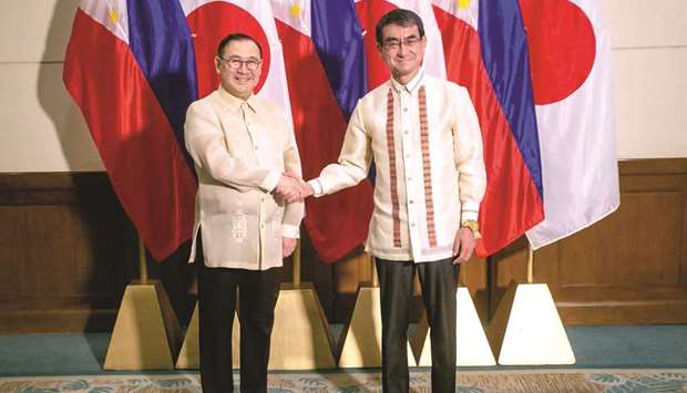 Foreign Affairs Secretary Teodoro Locsin shakes hands with Japanese Foreign Minister Taro Kono (right) prior to an expanded bilateral meeting in Davao, in the southern island of Mindanao, yesterday.