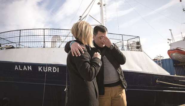 Abdullah Kurdi and his sister Tima in front of a Sea-Eye rescue boat named after his son Alan.