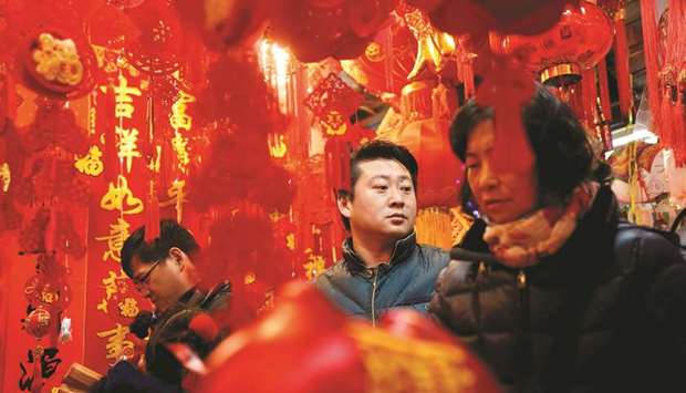 People shop for Chinese Lunar New Year decorations in Yu Yuan Garden in Shanghai.