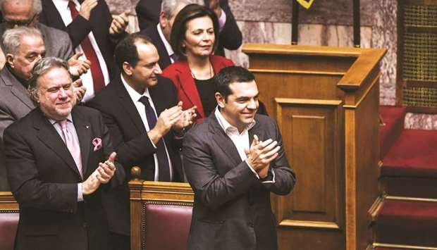 File photo of Greek Prime Minister Tsipras celebrating after the voting session on the agreement aimed at ending a 27-year bilateral row by changing the name of Macedonia to the Republic of North Macedonia, at the Greek Parliament, in Athens.