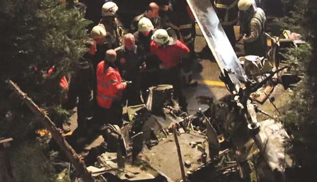 Firefighters and police inspect the site of the helicopter crash in Istanbul.