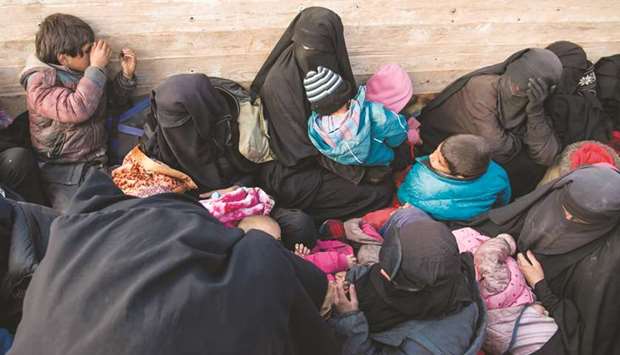 Women and children fleeing from the last Islamic State groupu2019s tiny pocket in Syria sit in the back of a truck near Baghouz, eastern Syria, yesterday.