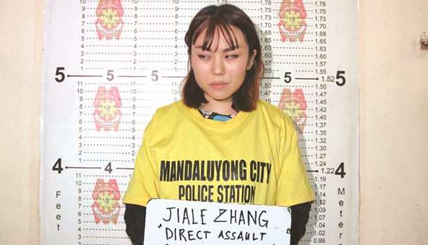 Jiale Zhang at the Mandaluyong City police station after throwing a cup of soy dessert at a police officer.