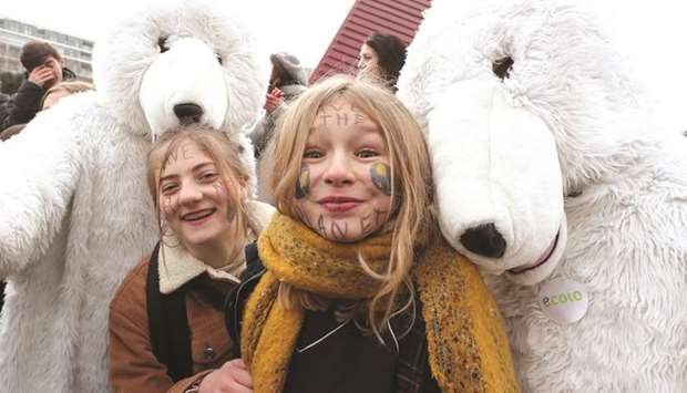 Students demanding urgent measures to combat climate change pose during a protest yesterday in central Brussels.