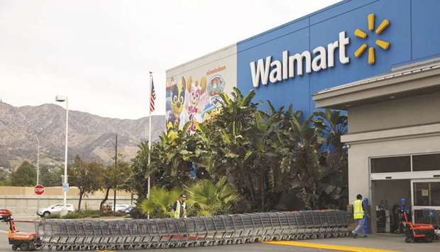 Employees push shopping carts outside a Walmart store in Burbank, California. Deliv, which was one of Walmartu2019s earliest partners with pilot programmes in Miami and San Jose, has served the retailer with a 90-day termination notice, and the two companies stopped working with each other in late January, according to two people familiar with the situation.