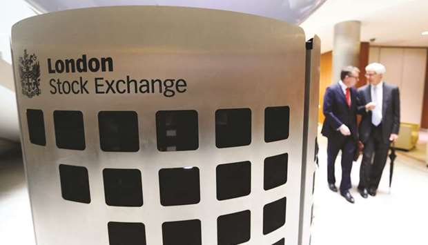 Visitors pass a sign inside the main atrium of the London Stock Exchange. The FTSE 100 closed up 0.1% to 7,133.14 points yesterday.