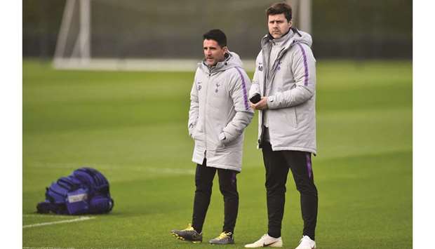 Tottenham Hotspuru2019s head coach Mauricio Pochettino (right) and assistant manager Jesus Perez watch their players take part in a training session in London yesterday. (AFP)