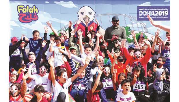 Qatar Olympic Committee (QOC) President HE Sheikh Joaan bin Hamad al-Thani with the kids after Falah (top right), the falcon, was revealed as the mascot for the IAAF World Athletics Championships Doha 2019 at Qatar Foundationsu2019s Awsaj Academy yesterday. PICTURES: Ram Chand