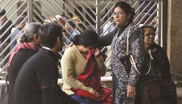 Relatives of victims who died in an early morning hotel wait at Ram Manohar Lohia Hospital in New Delhi yesterday.