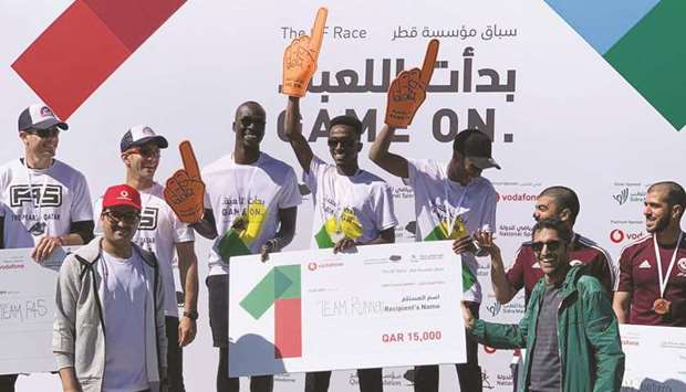 Vodafoneu2019s Mahday al-Hebabi with the winners of the QF Race.