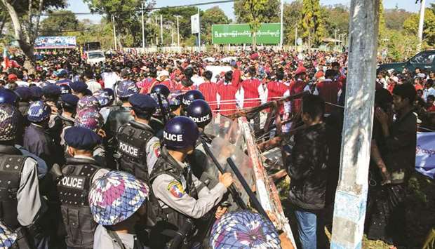 Police block protesters as they gather near a statue of General Aung San during a demonstration in Loikaw yesterday.