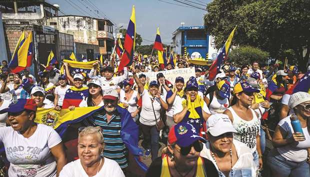 Supporters of Venezuelan opposition leader Juan Guaido, take part in a rally to press the military to let in US humanitarian aid, in Urena, Tachira State, Venezuela, on the border with Colombia, yesterday.