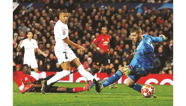 Paris Saint-Germainu2019s Kylian Mbappe (centre) scores past Manchester United goalkeeper David de Gea during the Champions League round of 16 first leg match at Old Trafford in Manchester on Tuesday night. (Reuters)