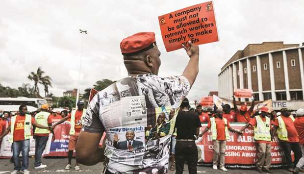 Members of the Congress of South African Trade Unions hold placards and shout slogans during a demonstration in Durban yesterday.