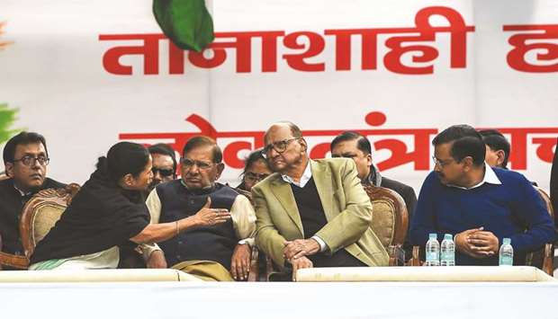 West Bengal Chief Minister Mamata Banerjee speaks with Nationalist Congress Party president Sharad Pawar as Loktantrik Janata Dal leader Sharad Yadav and Delhi Chief Minister Arvind Kejriwal look on at an opposition rally in New Delhi yesterday.