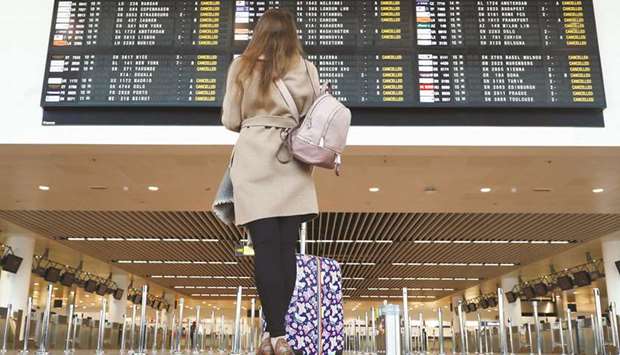 A stranded passenger looks at a flight information board displaying cancelled flights during a strike yesterday by Belgian trade unions at Zaventem international airport near Brussels.