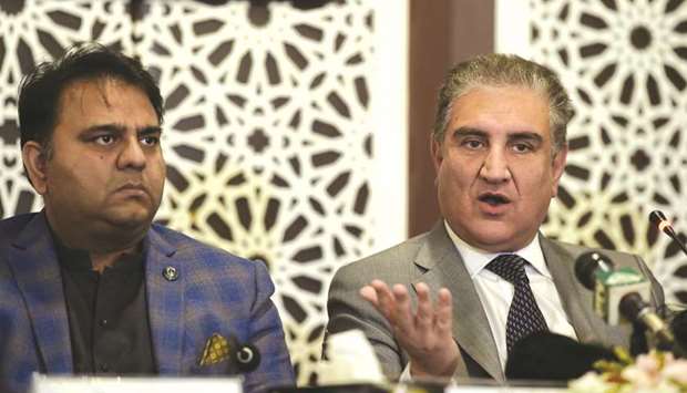Pakistani Foreign Minister Shah Mehmood Qureshi, right, speaks next to Minister of Information and Broadcasting Fawad Chaudhry during a press conference in Islamabad yesterday.