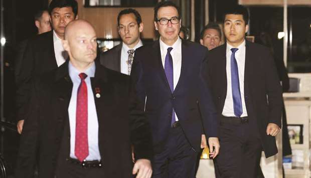 US Treasury Secretary Steven Mnuchin (2nd from right), a member of the US trade delegation to China, arrives at a hotel after talks with Chinese officials in Beijing. Mnuchin said he was looking forward to trade talks with China yesterday, as discussions in Beijing moved to a higher level in a push to de-escalate a tariff war ahead of a March 1 deadline for a deal.