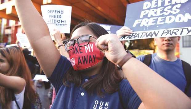 Students hold placards as they shout slogans during a protest at the state university grounds in Manila yesterday in support of CEO of Rappler, Maria Ressa, who was arrested a day earlier for cyber libel case.
